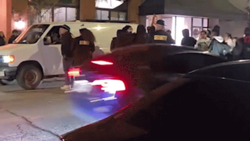 car driving through crowd